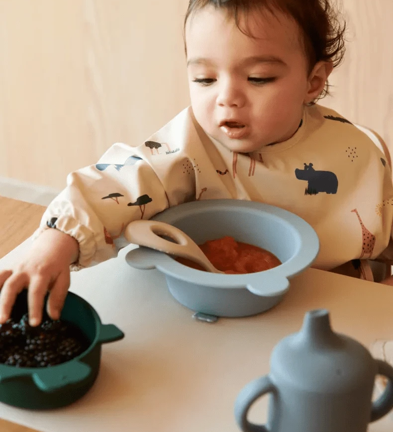Nepromokavý bryndák s rukávy LIEWOOD Merle Safari / Sandy | Lavly.cz